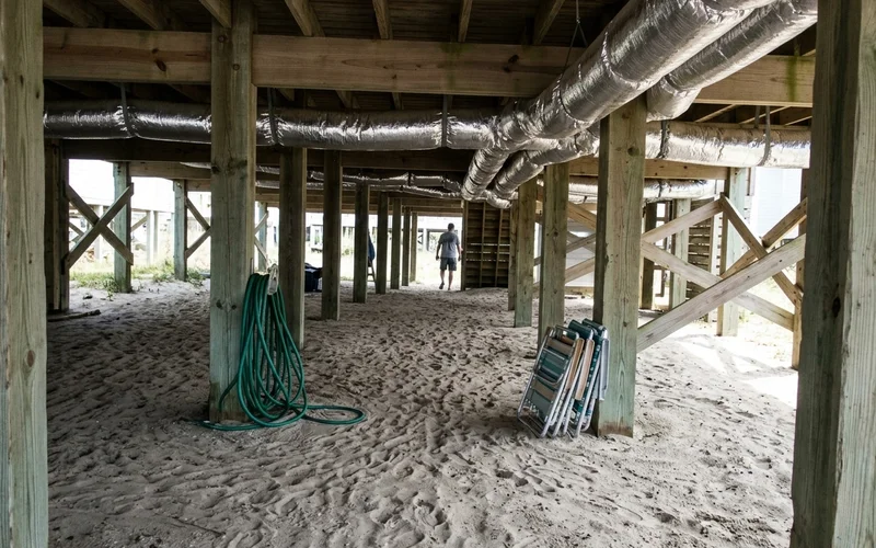 Ductwork running under the floor of a raised beach house