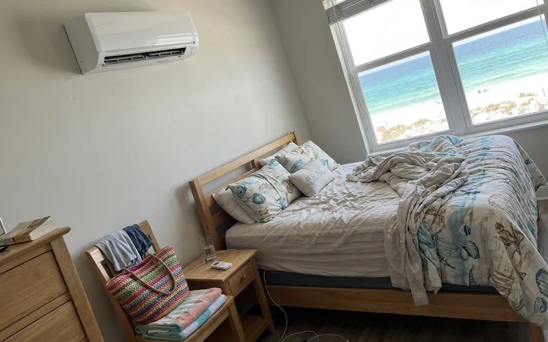Mini-split head above a bed in an Orange Beach condo bedroom