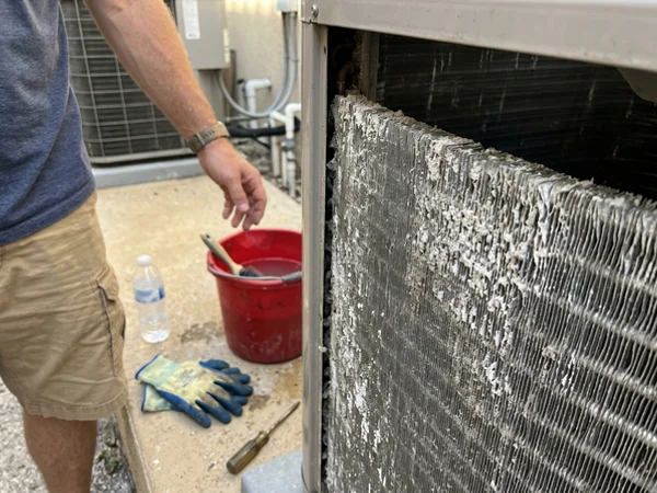 Salt-crusted outdoor AC coil fins before cleaning