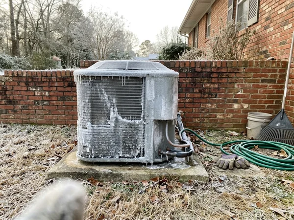 Heat pump coil encased in thick ice after a freezing night