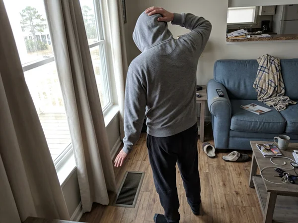 Person checking a floor vent in a chilly living room