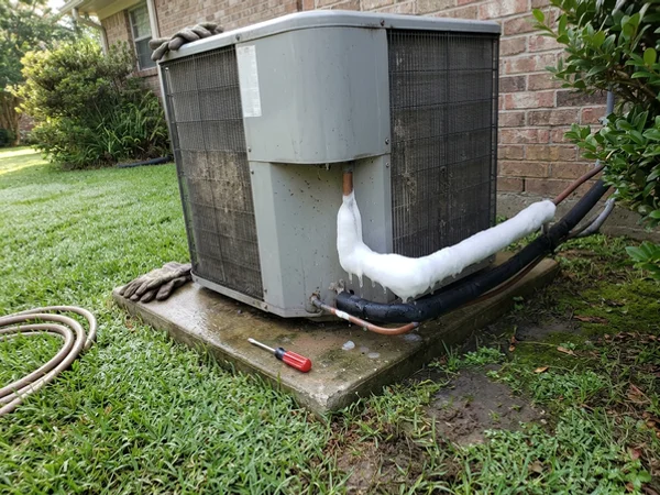 Ice on the copper suction line at an outdoor AC unit