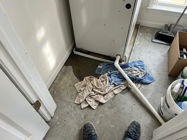 Water and towels on the floor of an air handler closet